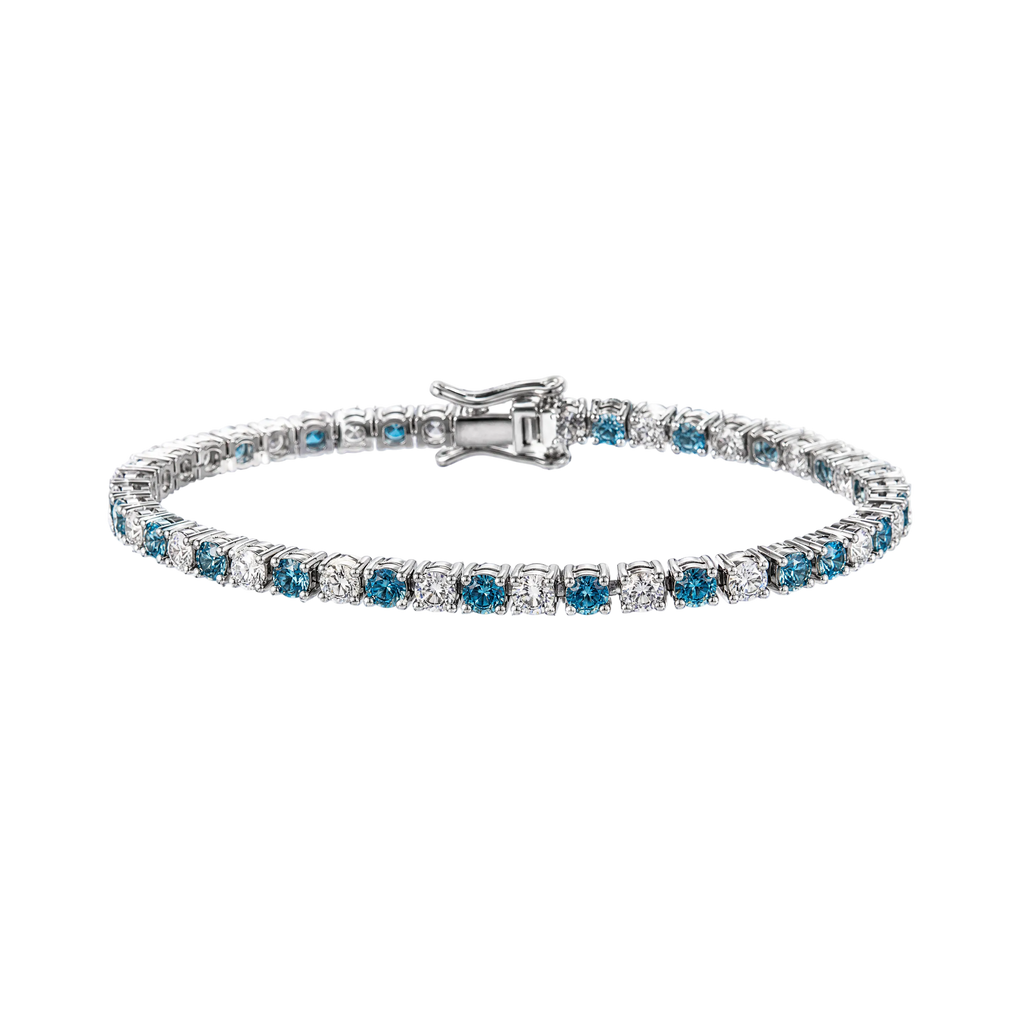 A tennis bracelet featuring round-cut blue sapphires and clear diamonds set in a silver-colored metal, shown against a plain white background.